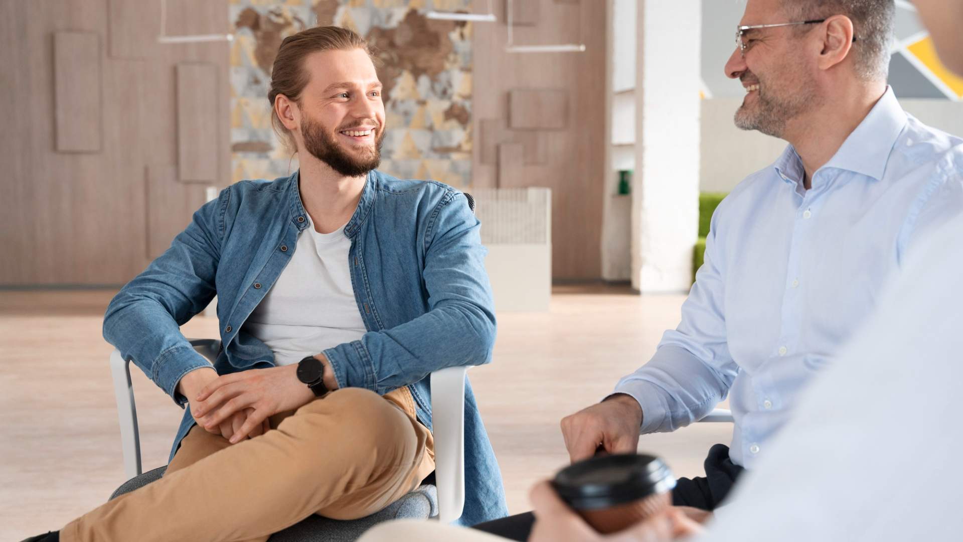 Hormone Replacement Therapy for Men in Centennial, CO consultation between two men speaking casually in a clinic setting
