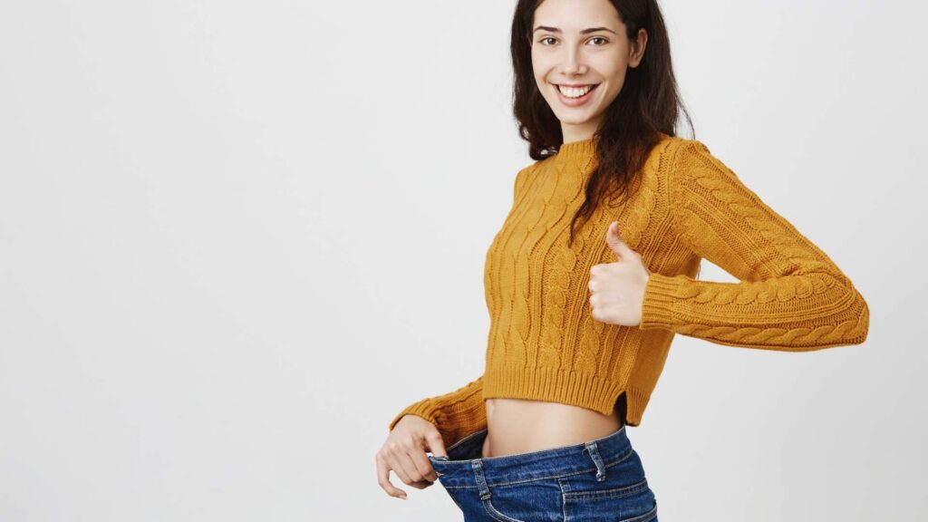 Woman wearing loose jeans after successful Weight Loss in Centennial, CO program